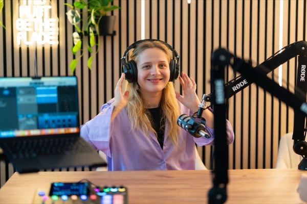 Podcaster putting on headphones before recording