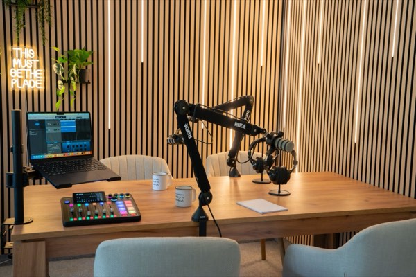 Studio Karlín – table with RØDE microphones, mixing desk and light strips on a wooden wall