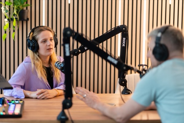 Two people recording a podcast conversation at RØDE microphones