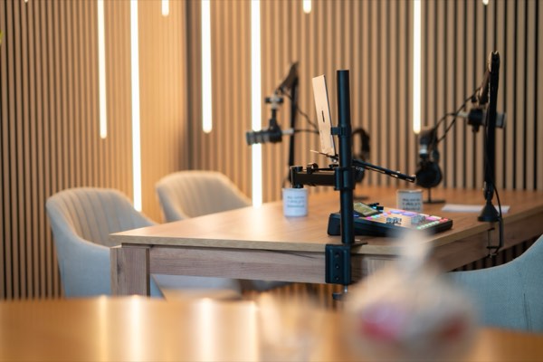 Table with microphones, a laptop on a stand and the mixing desk